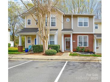 Inviting townhome exterior with manicured landscaping, brick accents, and convenient parking at 8364 Chaceview Ct, Charlotte, NC 28269