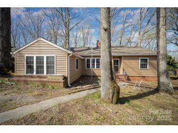 Charming single-story home featuring a cozy front porch and well-maintained landscaping at 116 S Westover Dr, Monroe, NC 28112