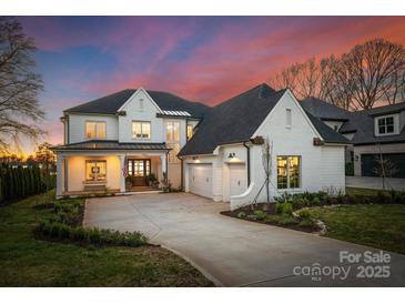 Stunning two-story home with a three-car garage, manicured lawn, and inviting front porch at 20637 Island Forest Dr, Cornelius, NC 28031