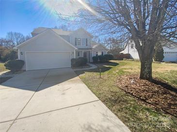 Charming two-story home featuring a well-maintained lawn, attached garage, and inviting curb appeal at 2115 Genesis Dr, Monroe, NC 28110