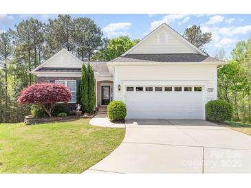 Charming single-Gathering home with a well-manicured lawn, mature trees, and a two-car garage at 3052 Santee Ct, Indian Land, SC 29707