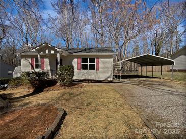 Charming home featuring a carport and inviting front porch with vibrant red shutters and door at 426 W Ballard St, Cherryville, NC 28021