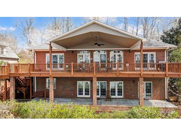 Brick home with a spacious deck and covered patio, perfect for outdoor entertaining at 4633 River Bluff Ct, Charlotte, NC 28214