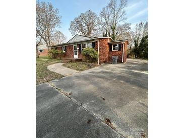 Charming one-story brick home with a concrete driveway and a well-maintained front yard at 502 Mcconnell St, Clover, SC 29710