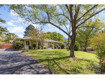 Charming ranch-style home with a spacious front yard and mature trees at 7212 Hackberry Ln, Charlotte, NC 28226