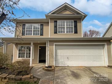 Charming two-story home with a two car garage and beautifully landscaped front yard at 8715 Green Ivy Ln, Charlotte, NC 28217