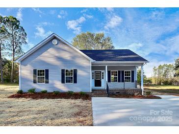 Charming single-story home with a cozy front porch and well-manicured lawn under a bright blue sky at 914 Saluda St, Rock Hill, SC 29730