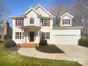 Charming two-story home with red shutters, a well-manicured lawn, and a two car garage at 9144 Cameron Wood Dr, Charlotte, NC 28210