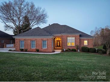Charming brick home featuring a well-manicured lawn, mature landscaping, and a welcoming front entrance at 110 49Th Avenue Nw Pl, Hickory, NC 28601