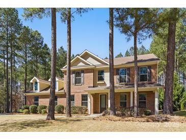 Charming two-story brick home with a well-manicured front yard and mature trees at 160 Belfry Loop, Mooresville, NC 28117