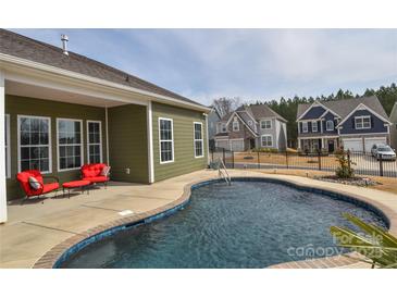 Inviting backyard pool with an outdoor seating area perfect for relaxation and entertaining guests at 1638 Sweetmoss Loop, Denver, NC 28037