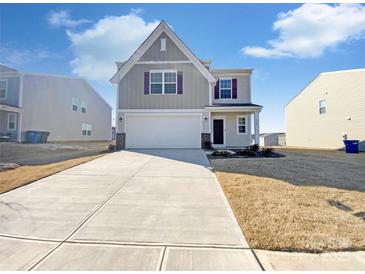 Charming two-story home with a two-car garage and a well-manicured front yard at 174 Hanging Rock Trl # 104, Statesville, NC 28625