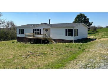 Charming home featuring a front porch, dark shutters, and a well maintained lawn at 24257 Austin Rd, Albemarle, NC 28001