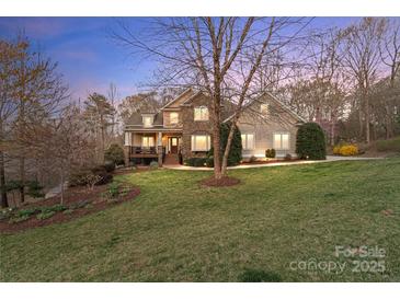 Charming two-story home with stone accents and a well-manicured lawn at 3196 Stonemill Path, Sherrills Ford, NC 28673