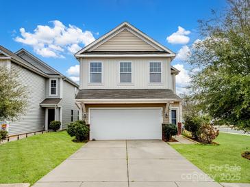 Charming two-story home with a two-car garage, a well-manicured lawn, and beautiful landscaping at 5247 Crystal Lakes Dr, Rock Hill, SC 29732