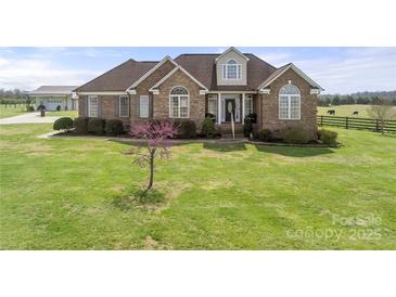 Beautiful brick home with a well-manicured lawn and lovely landscaping details at 6808 Austin Grove Church Rd, Marshville, NC 28103