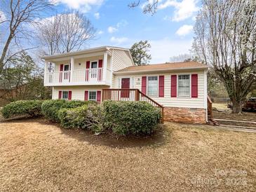 Charming two-story home with front balcony, manicured bushes, and red shutters at 755 Ottawa Dr, Rock Hill, SC 29732