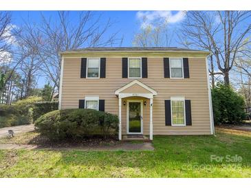 Traditional two-story home with a well-manicured lawn and classic architectural details at 8501 Golf Ridge Dr, Charlotte, NC 28277