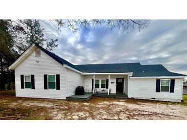 Charming single-story home with white siding, black shutters, covered front porch and well-kept lawn at 102 Guffey Rd, Cherryville, NC 28021