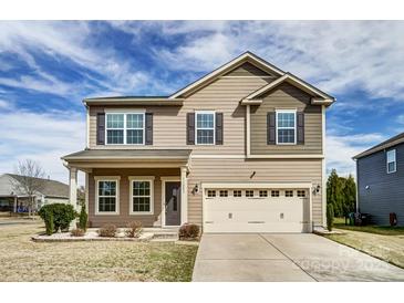 Charming two-story home showcasing a neutral color palette, well-maintained landscaping, and a two-car garage at 11203 Chapeclane Rd, Charlotte, NC 28278