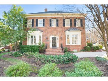 Charming brick two-story home featuring black shutters and manicured landscaping at 1131 S Kings Dr, Charlotte, NC 28207