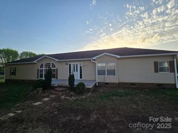 Charming single-story home with light siding, front porch, well-manicured lawn, and inviting entrance at 117 Jones Rd, Shelby, NC 28150