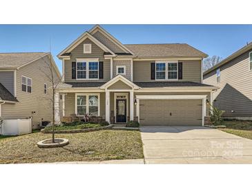 Charming two-story home with a welcoming front porch, a well-manicured lawn, and a two-car garage at 120 Hornbeam Ln, Mooresville, NC 28117