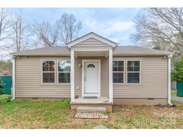 Charming single-story home featuring a covered front porch, neutral siding, and double-pane windows at 1216 Center St, Wadesboro, NC 28170