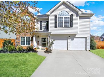 Charming two-story home with a well-manicured lawn and a two-car garage, offering curb appeal and modern convenience at 311 Glenn Allen Rd, Mooresville, NC 28115
