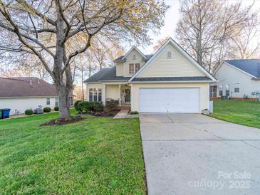 Charming yellow two-story home with a well-maintained front lawn and a two-car garage at 3229 Leicester Dr, Matthews, NC 28104