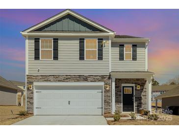 Attractive two-story home with stone accents, an attached garage, and a well-maintained lawn at 3309 Colorado Blue Ct, Gastonia, NC 28056
