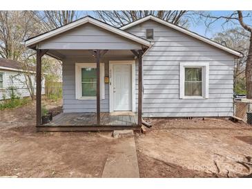 Charming single-story home featuring a covered porch, neutral siding, and a well-maintained yard at 402 N Boyd St, Gastonia, NC 28052