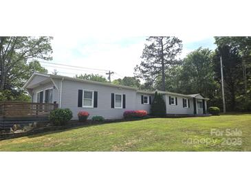 Charming single-story home with gray siding, black shutters, and a well-manicured lawn at 4790 Polk Ford Rd, Stanfield, NC 28163