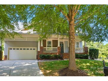 Charming home featuring a two-car garage, well-manicured lawn, and inviting front porch at 8008 Battersea Ct, Waxhaw, NC 28173