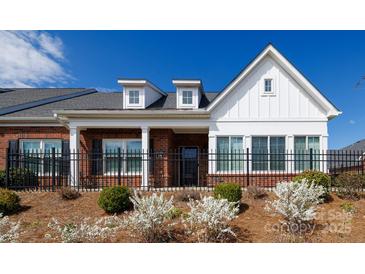 Charming brick and white facade with a black fence and manicured landscaping at 126 Adelaide Way, Rock Hill, SC 29732