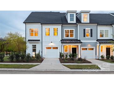 Charming new construction townhome featuring a garage, landscaping, and modern architectural details at 3063 Finchborough Ct # 216, Charlotte, NC 28269