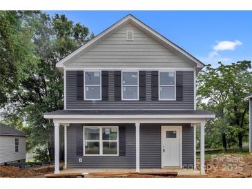 Charming two-story home with gray siding, black shutters, and a welcoming front porch at 515 Harrel St, Salisbury, NC 28144
