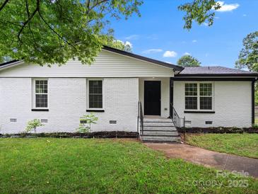 Charming white brick home with black trim, landscaped front yard, and inviting entryway steps at 5316 Rupert Ln, Charlotte, NC 28215