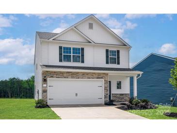 Two-story home featuring stone accents, white siding, a two-car garage and black shutters at 5704 Skinny Dr, Charlotte, NC 28215