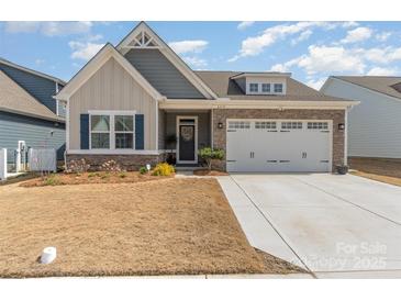 Charming single-Gathering home featuring stone accents and a two-car garage at 6419 Cambridge Dr, Harrisburg, NC 28075