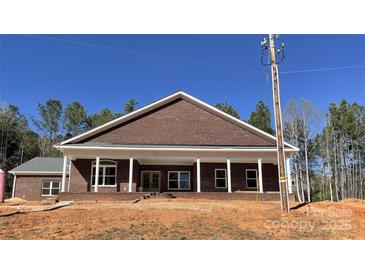 Charming brick home featuring a column-lined front porch, offering a welcoming curb appeal and stylish design at 1199 Brunson Rd, Fort Lawn, SC 29714