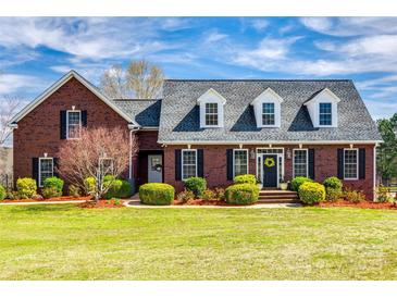 Stately brick home featuring a manicured lawn, mature landscaping, and a welcoming front entrance at 1790 Faires Rd, Rock Hill, SC 29730