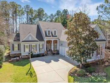 Charming traditional-style home with an inviting entryway, three-car garage and a well-manicured front yard at 4536 Rustling Woods Dr, Denver, NC 28037