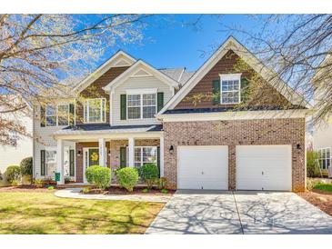 Charming two-story home featuring a brick front, two-car garage, and well-maintained landscaping at 10123 Barrands Ln, Charlotte, NC 28278