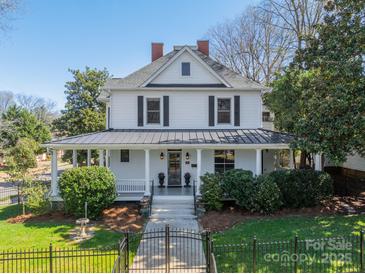 Charming two-story home featuring a welcoming front porch, mature landscaping, and classic architectural details at 234 N Race St, Statesville, NC 28677