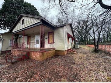 Modest home with a covered front porch and neglected yard at 2501 Booker Ave, Charlotte, NC 28216