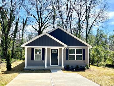 Charming exterior of a one-story home with a neatly landscaped front yard and concrete driveway at 347 Sidney St, Rock Hill, SC 29730