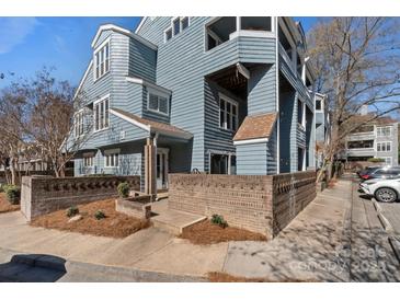 Charming blue condo exterior featuring brick accents, offering a unique and inviting curb appeal at 419 W 8Th St, Charlotte, NC 28202