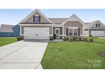 Charming single-Gathering home with a well-manicured lawn, inviting entrance, and attached two-car garage at 815 Foxmeade Ct, Salisbury, NC 28144