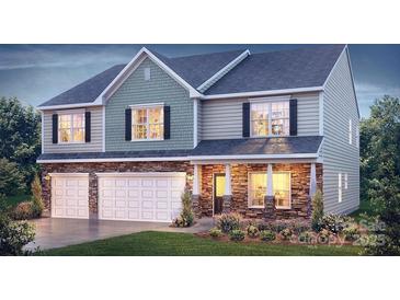 New two-story home with a three-car garage and stone accents at 203 Giant Oak Ave, Statesville, NC 28677